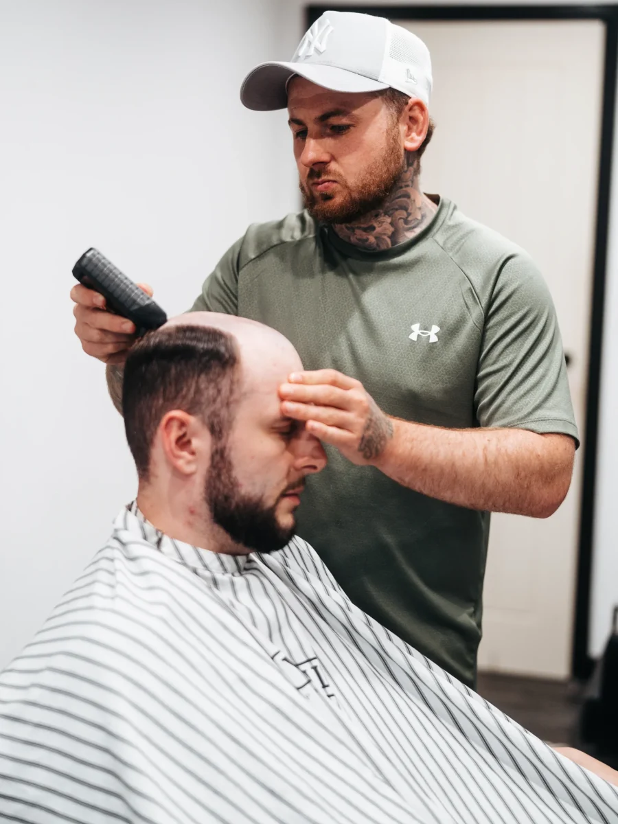 man having new hair system in Cardiff with barber